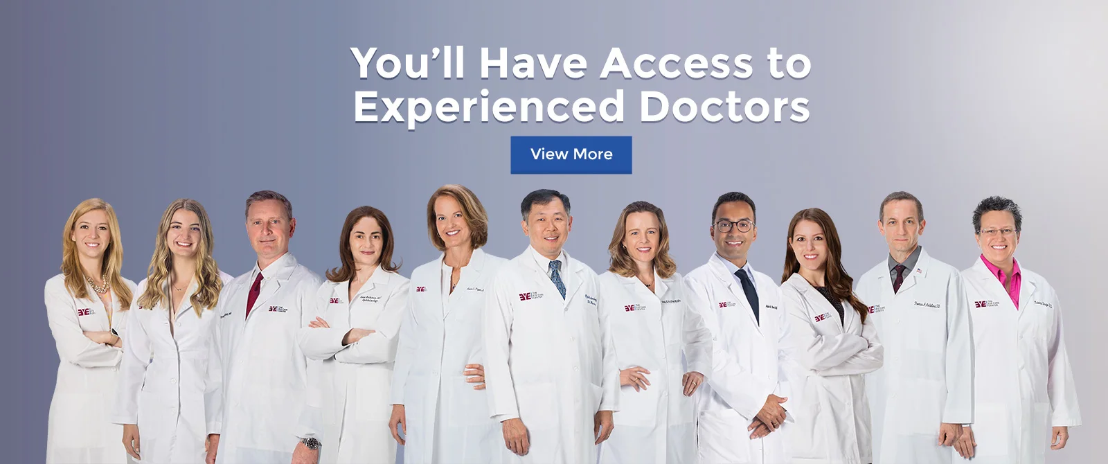 eleven doctors of the eye care center in white coats stand smiling