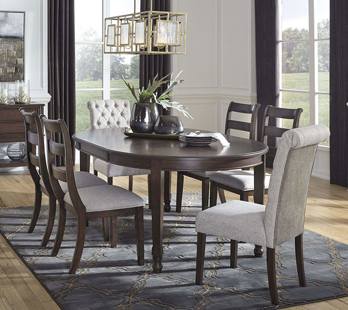 oval dining room table with six chairs in an elegant room