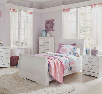 bedroom with white furniture, floral bedding, and pastel decor accents