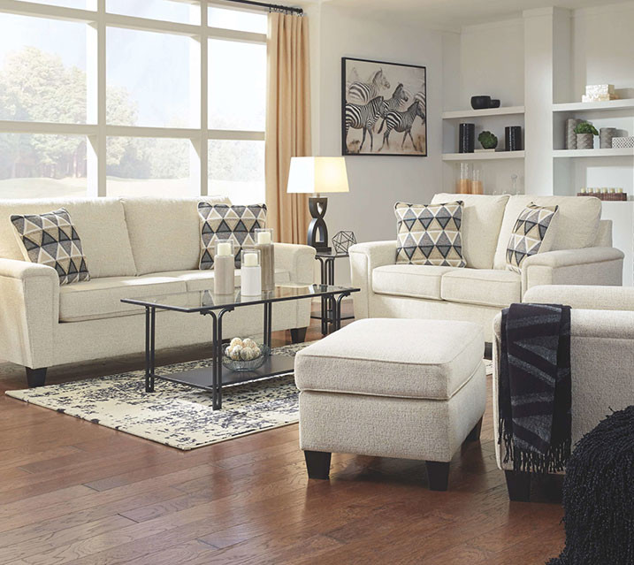 living room with beige sofas and glass coffee table