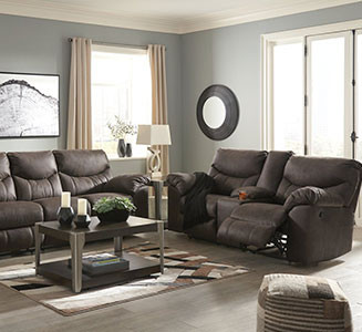 living room with dark sofas and a coffee table