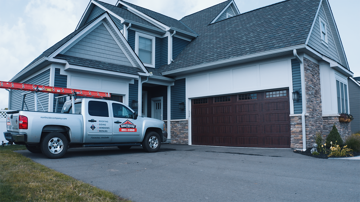 grey blue house with northside truck in the front