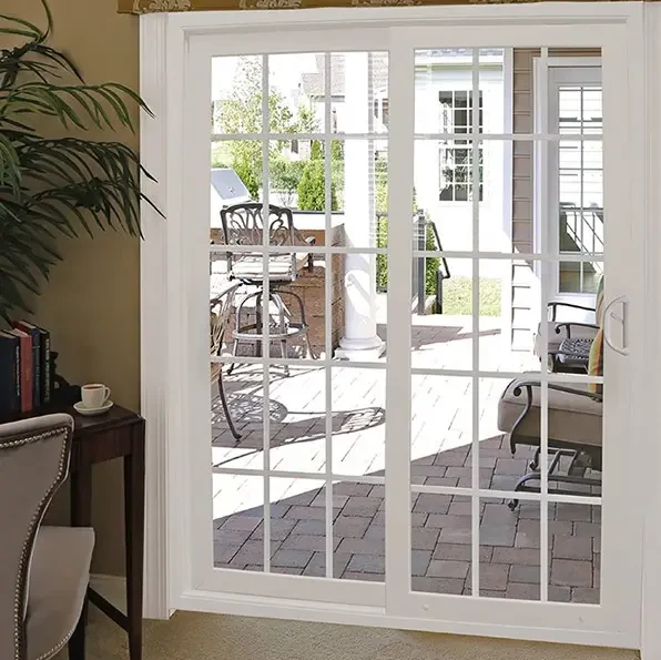 Brown wood front door with glass panels, a potted plant, and two black wall sconces.
