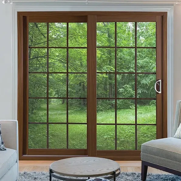 White front door with glass panels, yellow flowers, and a chair on a porch with wall lanterns.