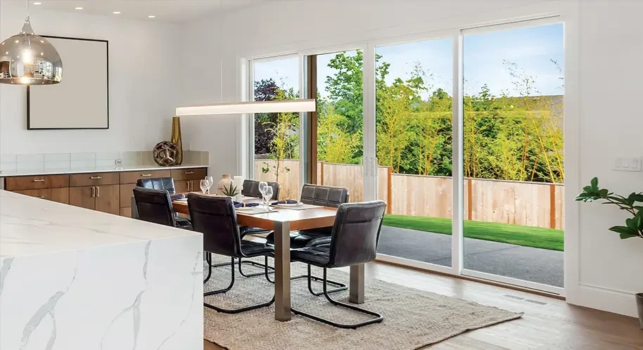 A black door with a silver handle in a modern room with striped walls and a wooden cabinet.