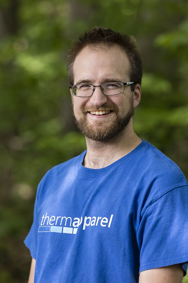 a man wearing glasses and a blue shirt