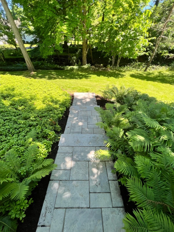 fresh flowers and mulch on home walkway
