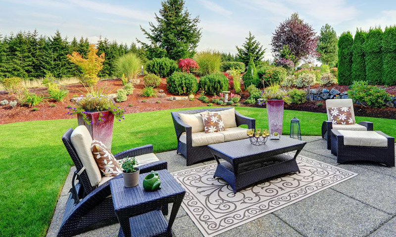 patio with a lush landscape behind it