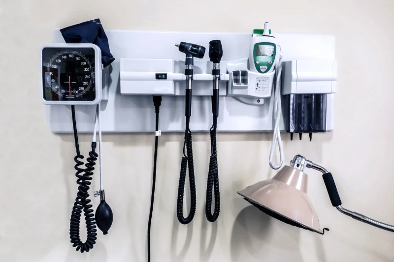 blood pressure cup, thermometer, and other medical supplies in medical office