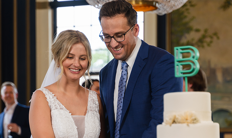 bride and groom cutting wedding cake