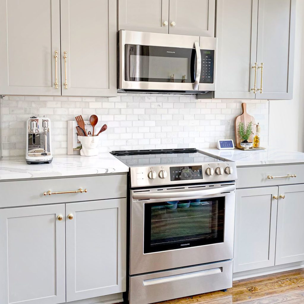 Kitchen oven, microwave, and cabinets