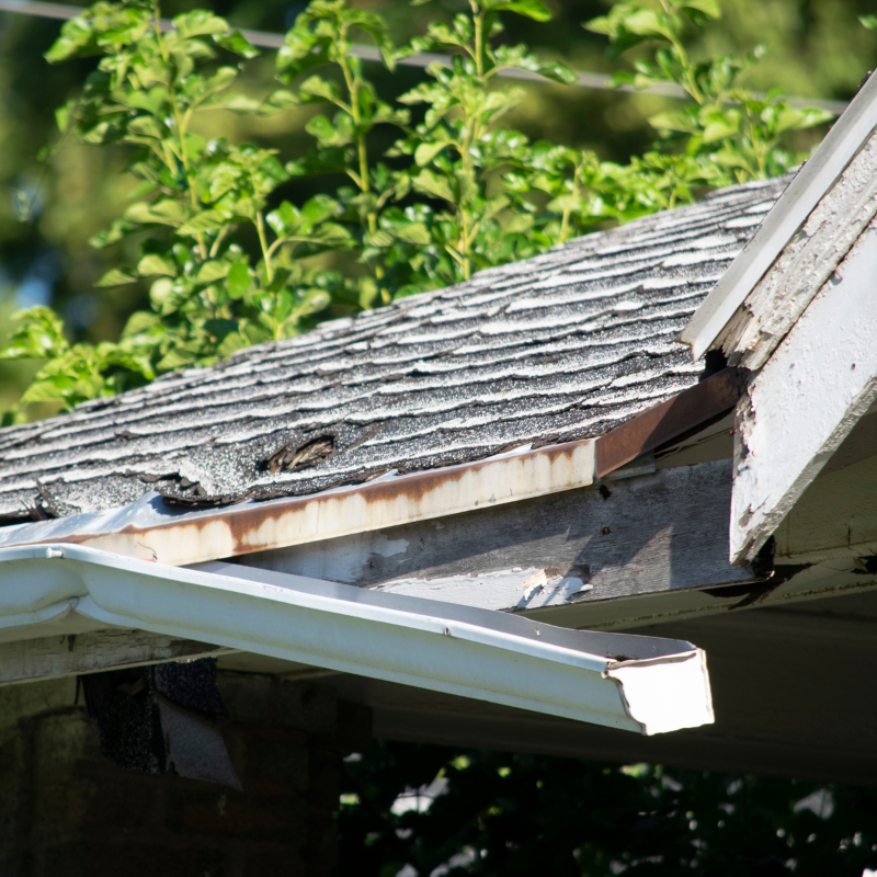 An old gutter breaking away from the roof