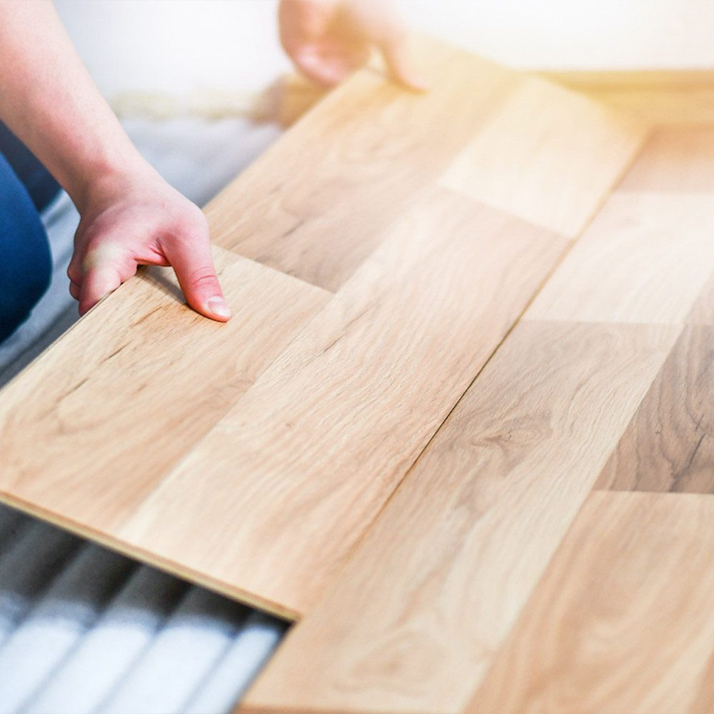 A handyman installing hardwood floors