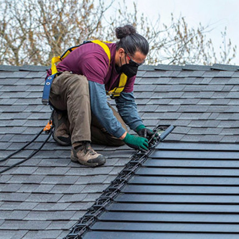 Contractor installing solar roof shingles