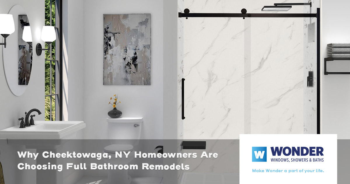 Modern bathroom with white fixtures, marble shower, wall art, and black accents for decoration.