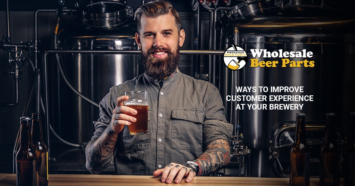 man with tattoos at a bar holding a pint of beer "ways to improve customer experience at your brewery"