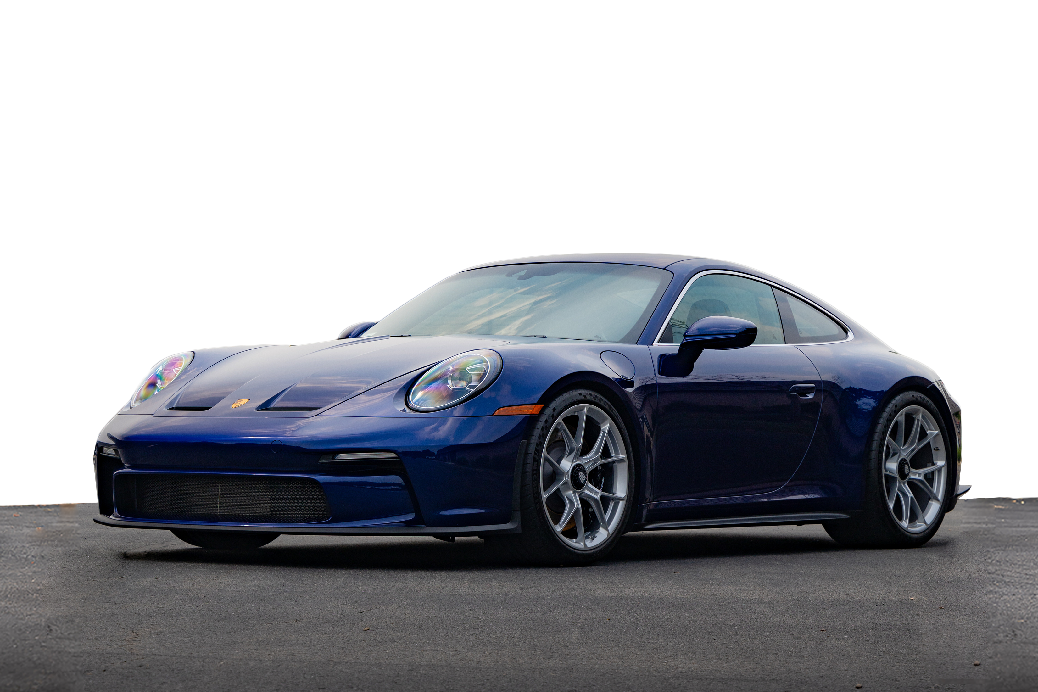 dark blue porsche in parking lot