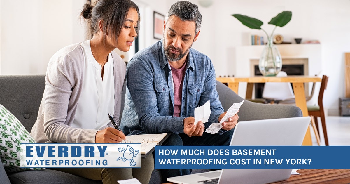 A couple reviews receipts and takes notes with How much does basement waterproofing cost? text.