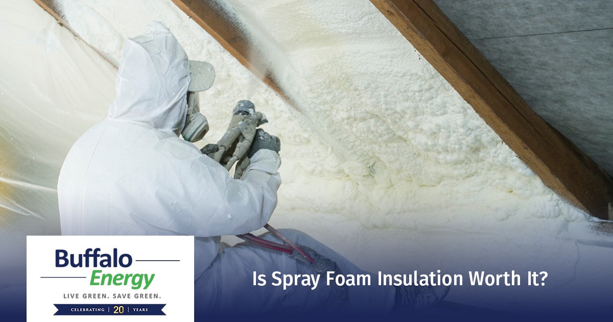 Person in protective gear spraying foam insulation on attic ceiling; text asks if its worth it.