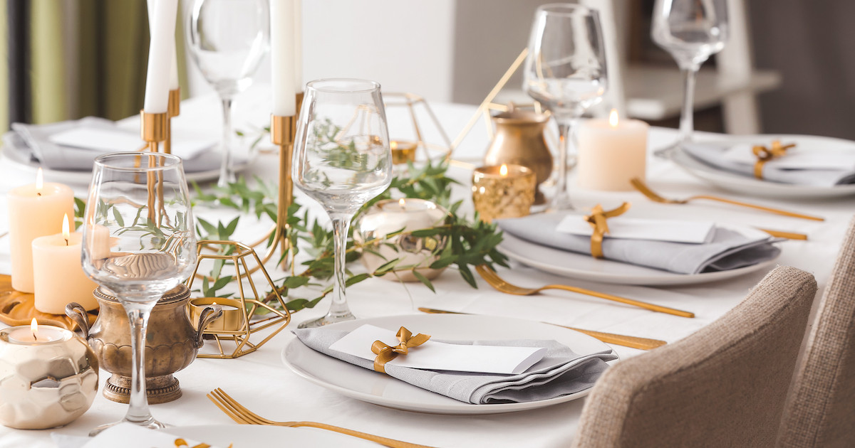 dinner table place settings with gold silverware