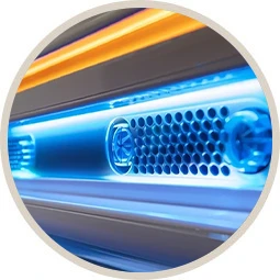 Close-up of a blue-lit metallic device with vents and an orange strip above it, viewed in a circle.