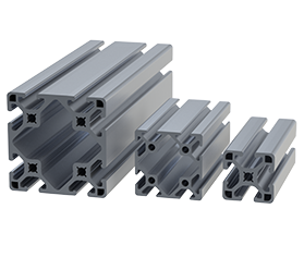 Three different sizes of gray aluminum T-slot structural framing profiles are shown standing vertically side by side. The profiles have a cross-sectional shape resembling a plus sign with spaces for bolts and connectors.