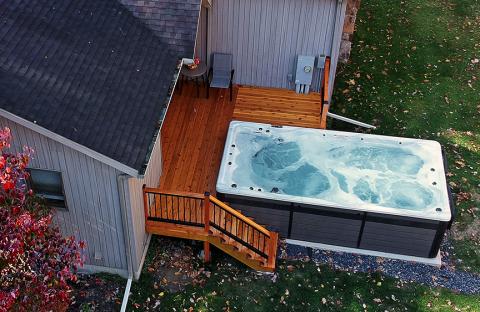 pdc spas splash series installed in backyard with deck