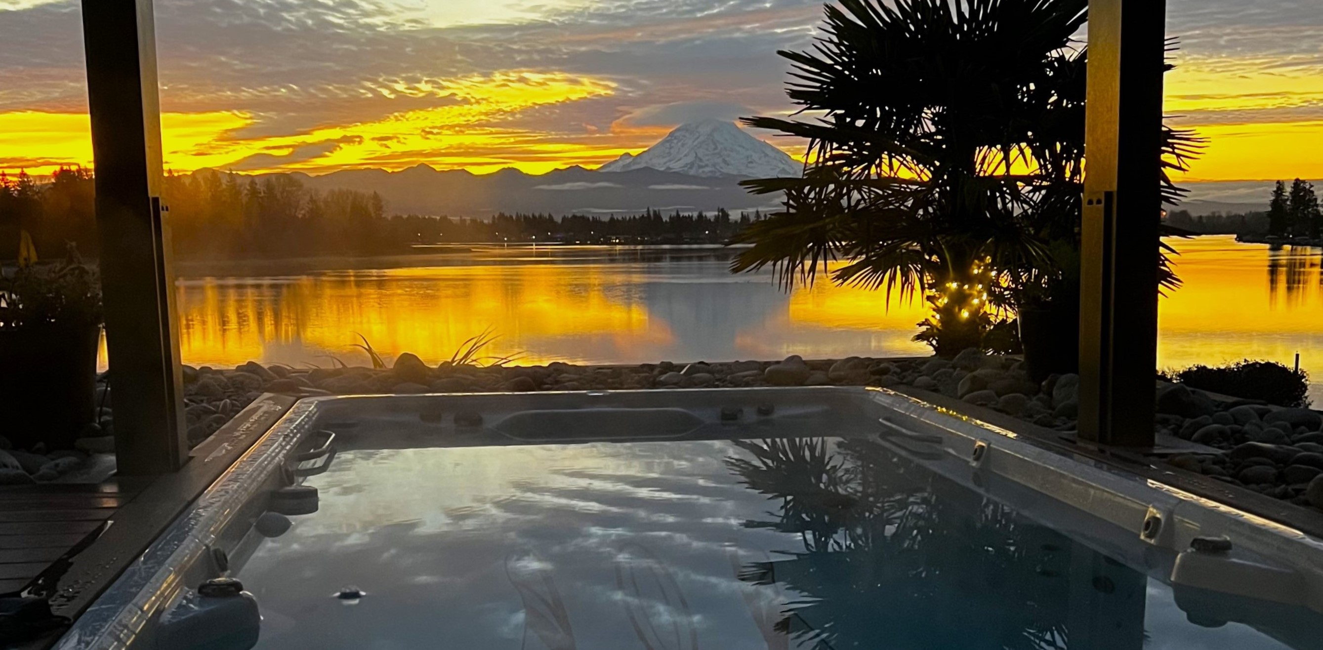 Swim spa outside with a river sunset