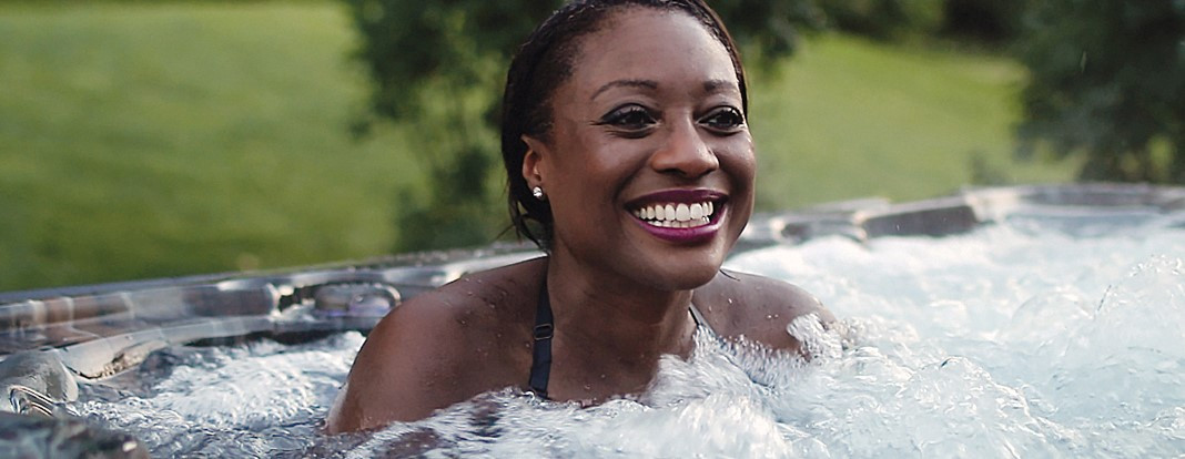 woman smiling in bubbling hot tub water