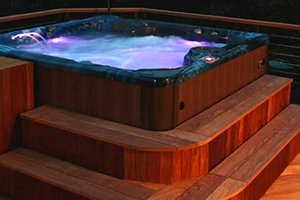 hot tub with jets on and purple hot tub lights