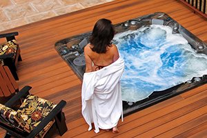 Woman getting in pdc spas hot tub