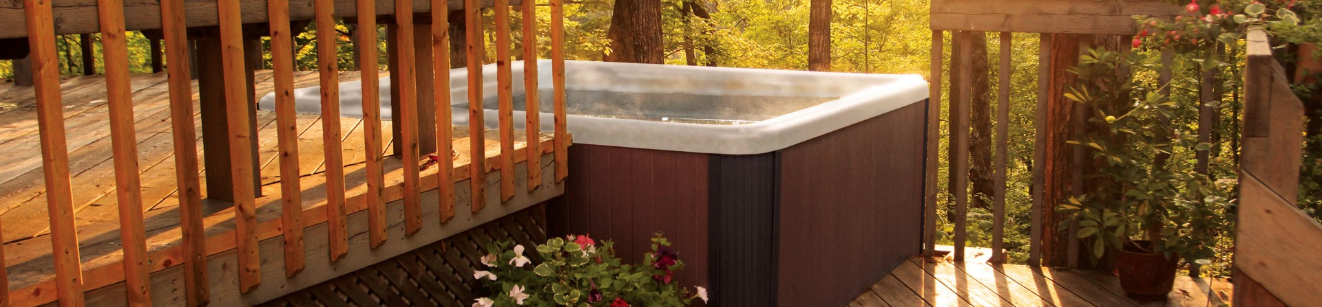 light colored hot tub with brown cabinet on deck