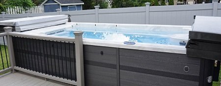 truswim swim spa installed next to deck with open covers on each end