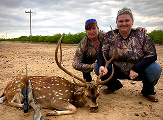 two woman with trophy deer