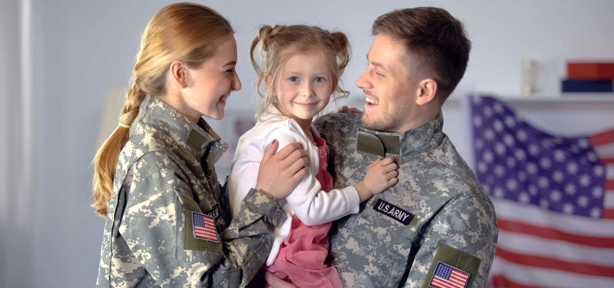 Military couple in uniform with daughter 