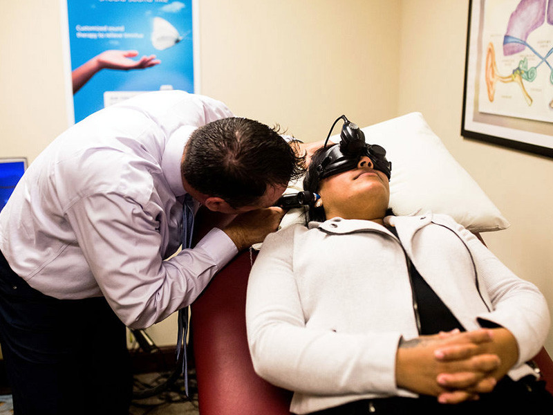 doctor at clear choice hearing and balance examining a woman for balance issues