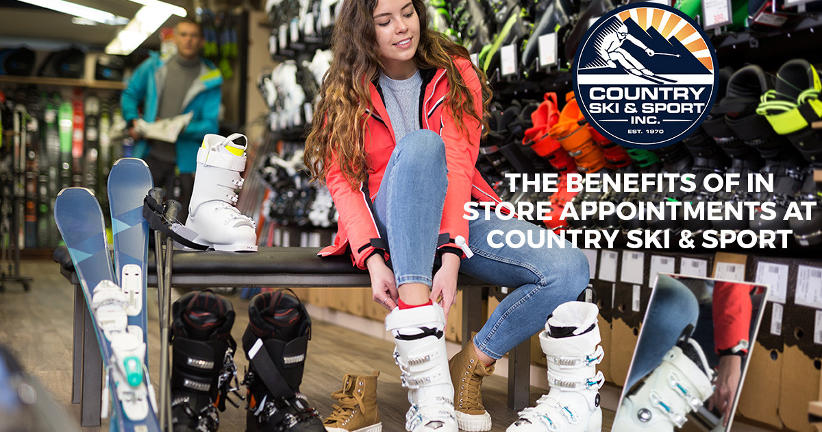 Woman trying on ski boots in store