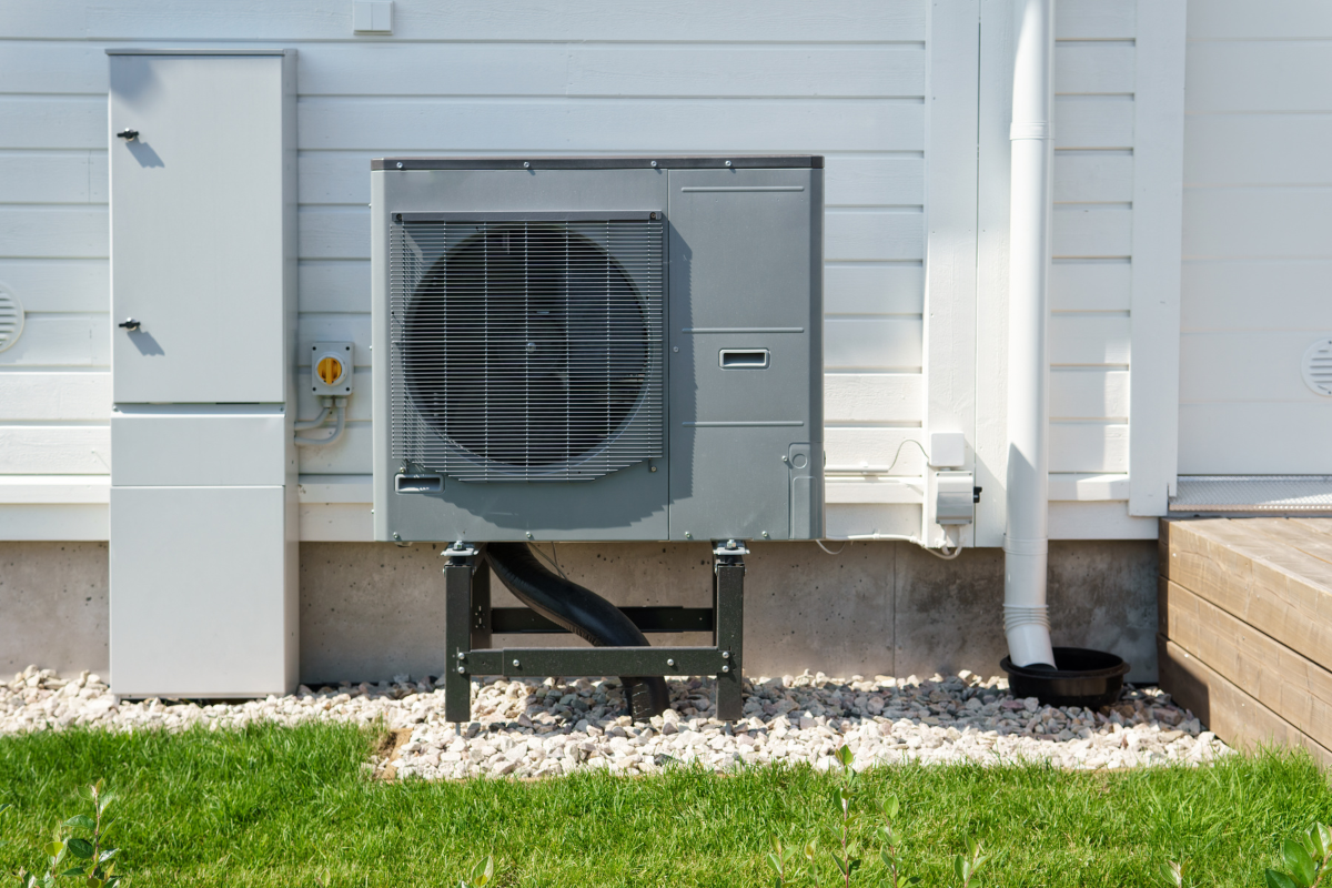 Heat pump installed outside a home on gravel base