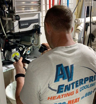 AV Enterprise technician working on water heater repair