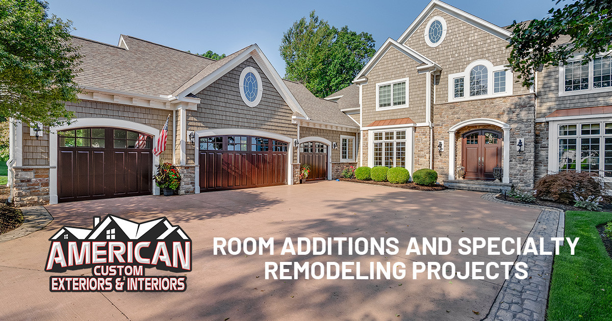 Home with cedar shingles, wooden garage door, and cooper roofing