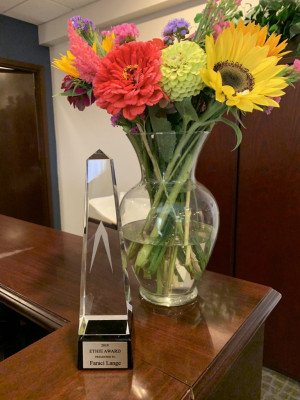 Award with Flowers At Faraci Lange Office