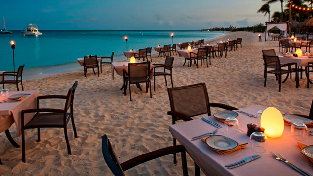 tables and chairs on a beach